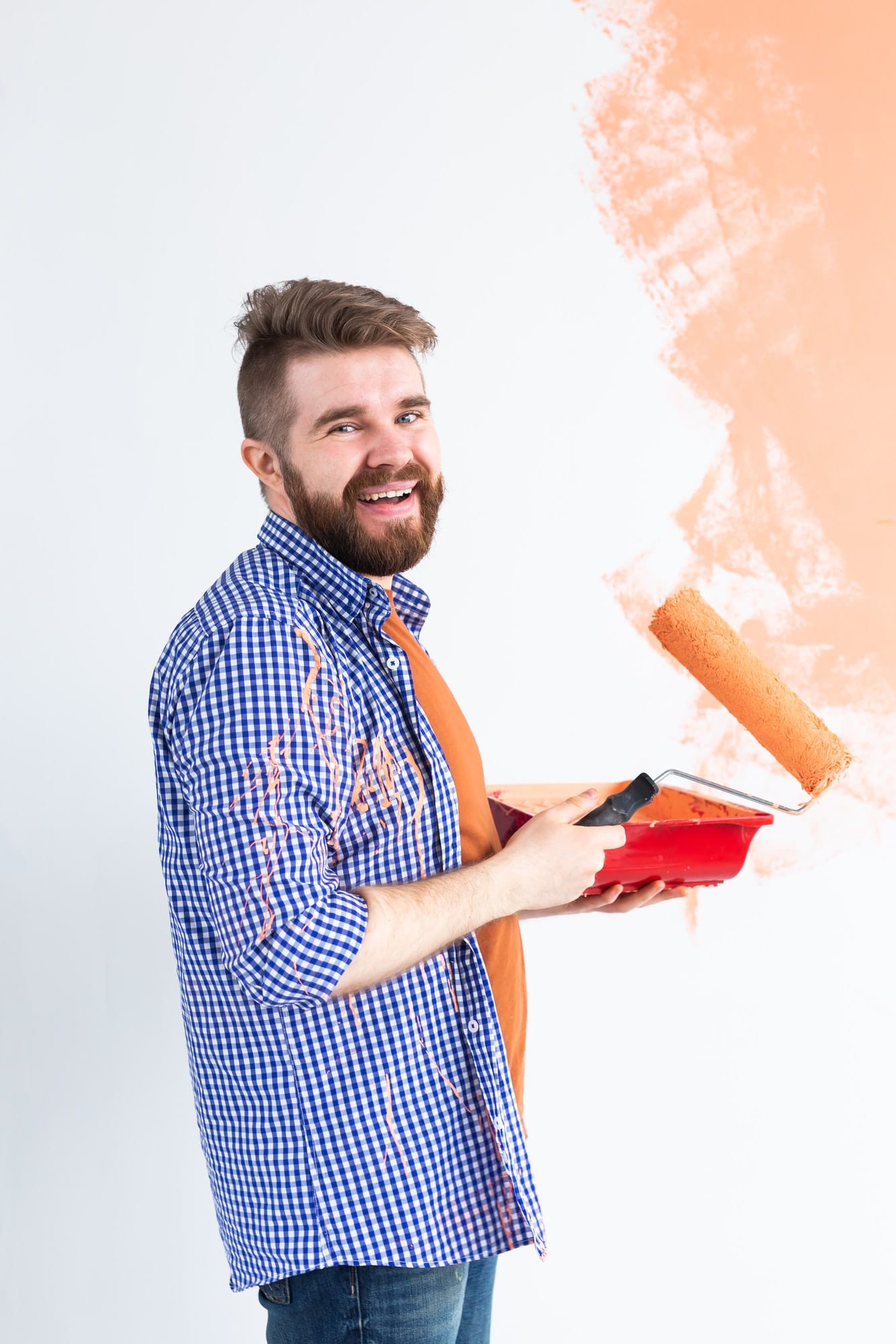 Man painting interior wall of new house. Redecoration, renovation, apartment repair and refreshment